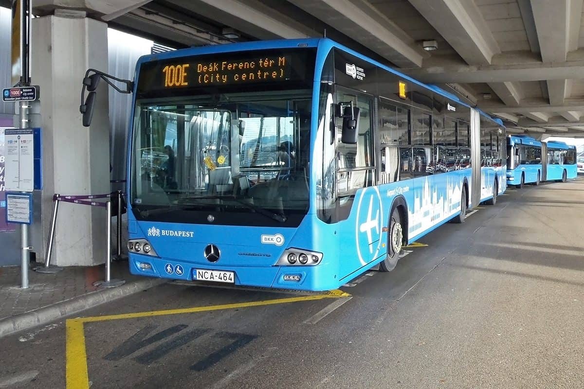 Detail of the 100E shuttle bus at its platform outside the Budapest Airport arrival level