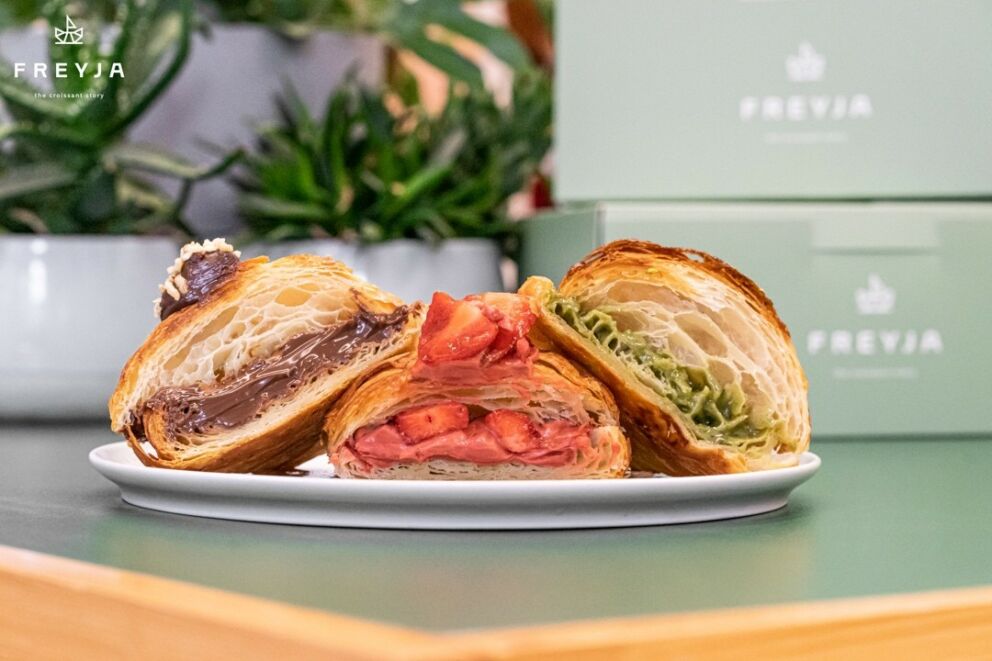 Mouth-watering photo of a chocolate, a fresh strawberry, and a 100% iranian pistachio croissant at Freyja, an amazing bakery in Budapest.