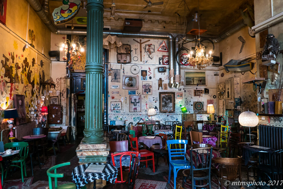 The surreal and colorful interior of Csendes Létterem Vintage Bar & Café, a unique ruin pub in Budapest