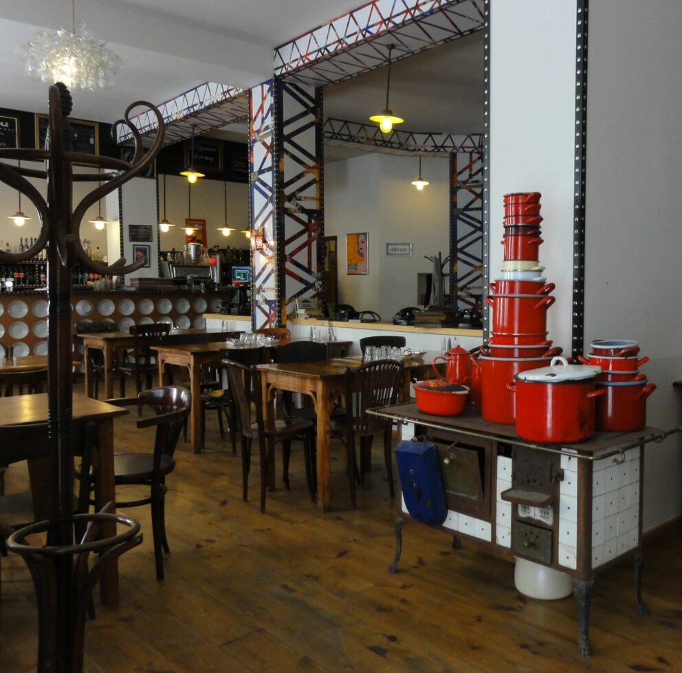 An old cooking stove and red pots at Kőleves restaurant in Budapest