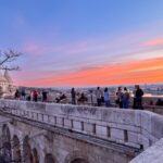 Tourists admiring the dawn at Fisherman's Bastion.