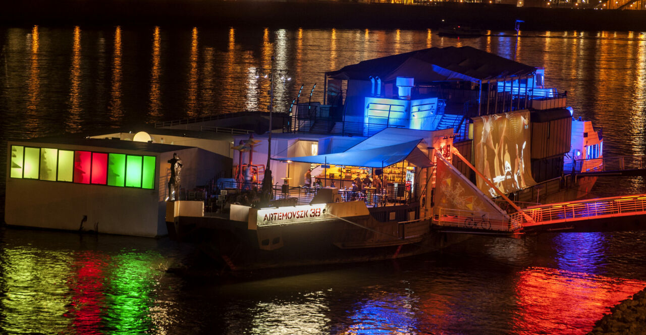 The iconic A38 Ship concert venue illuminated on the Danube River at twilight