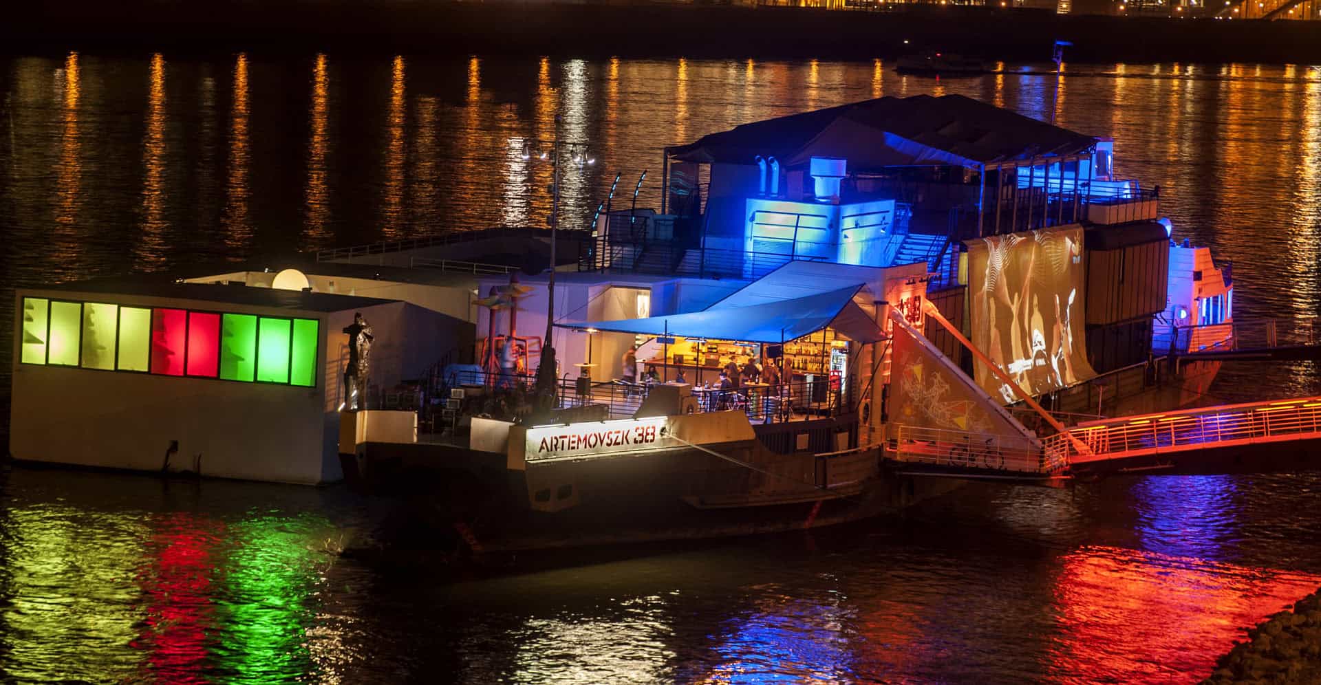 The A38 cultural ship illuminated at night on the Danube River in Budapest