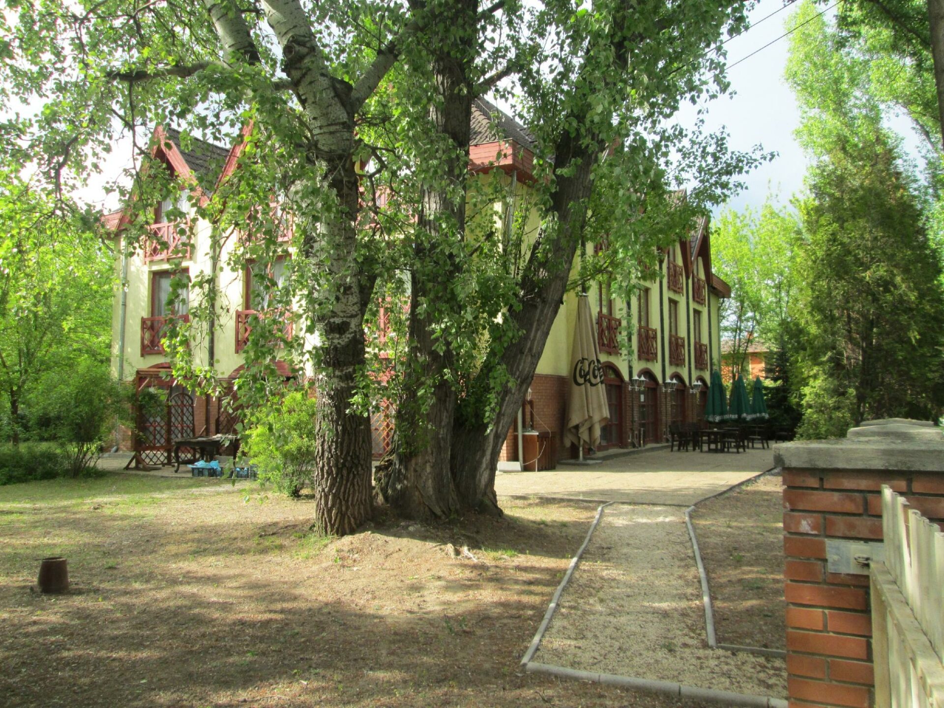 A traditional, well-kept affordable hotel room with twin beds and a desk