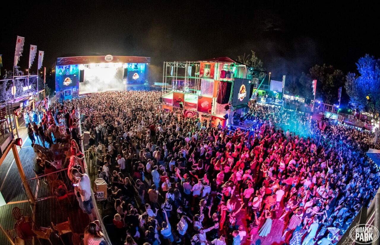 A live band performing on stage to a packed crowd inside the Akvárium Klub concert hall