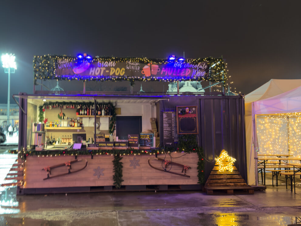 Colorful food vendor trailers serving classic snacks and cotton candy at the park
