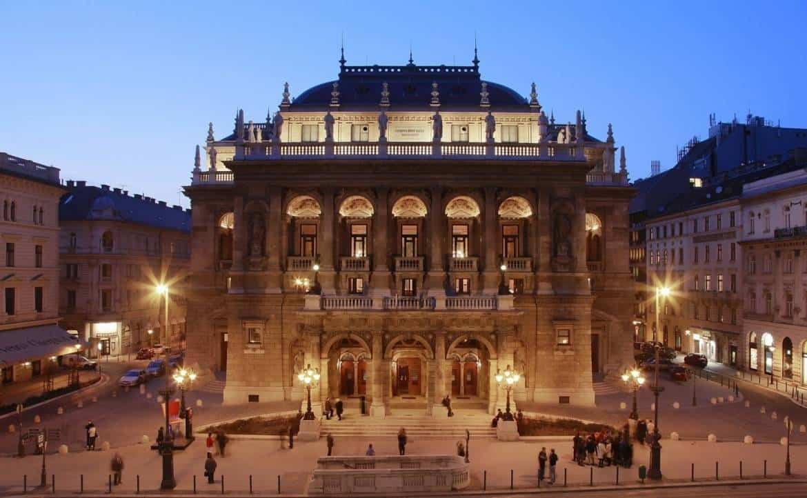 The illuminated exterior facade of the Hungarian State Opera House at night