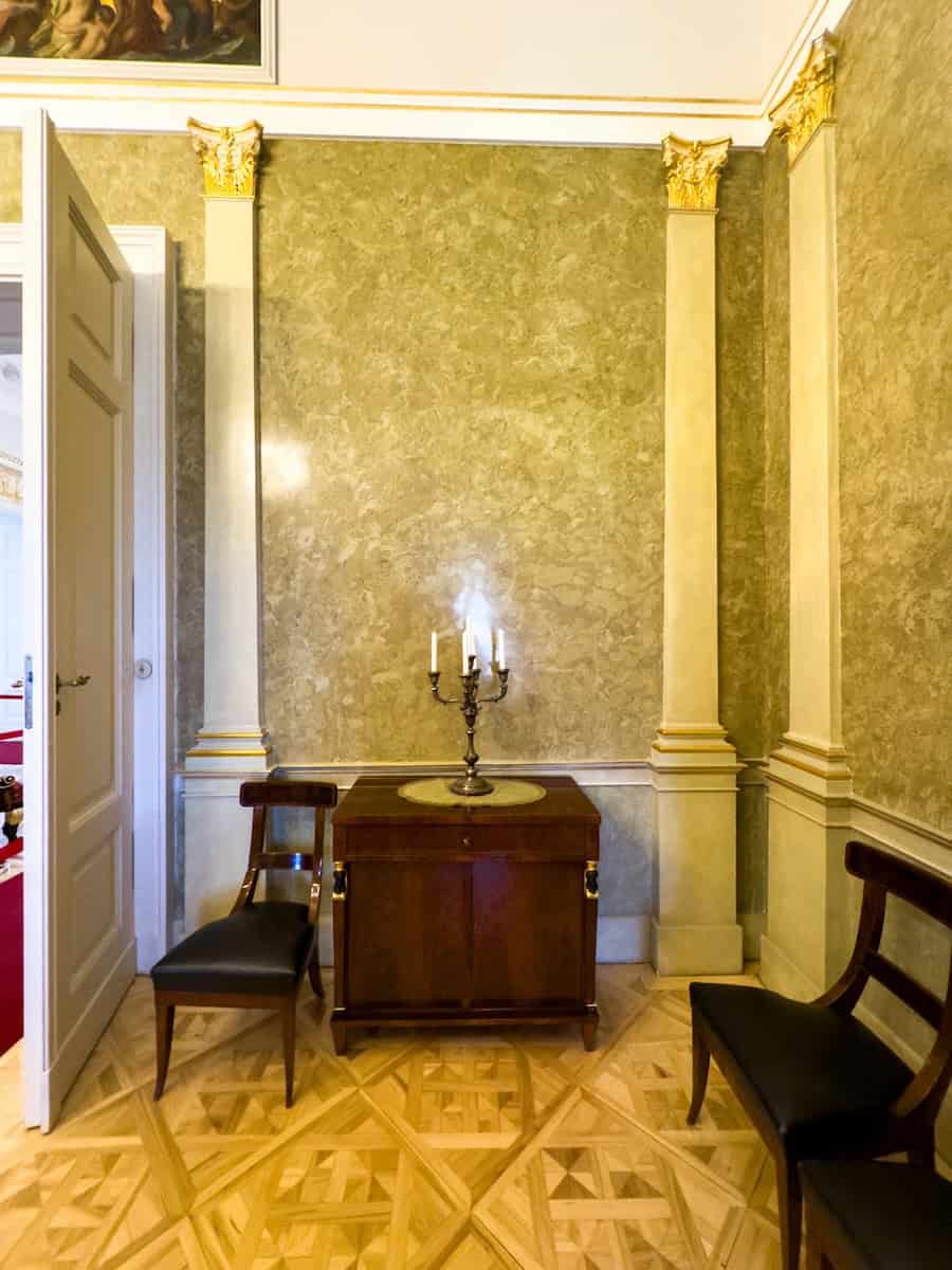 An ornate gilded candelabra standing in the Round Salon