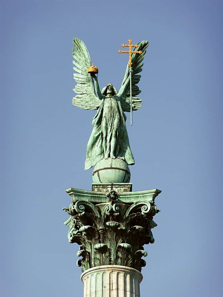The golden statue of Archangel Gabriel standing atop the central column