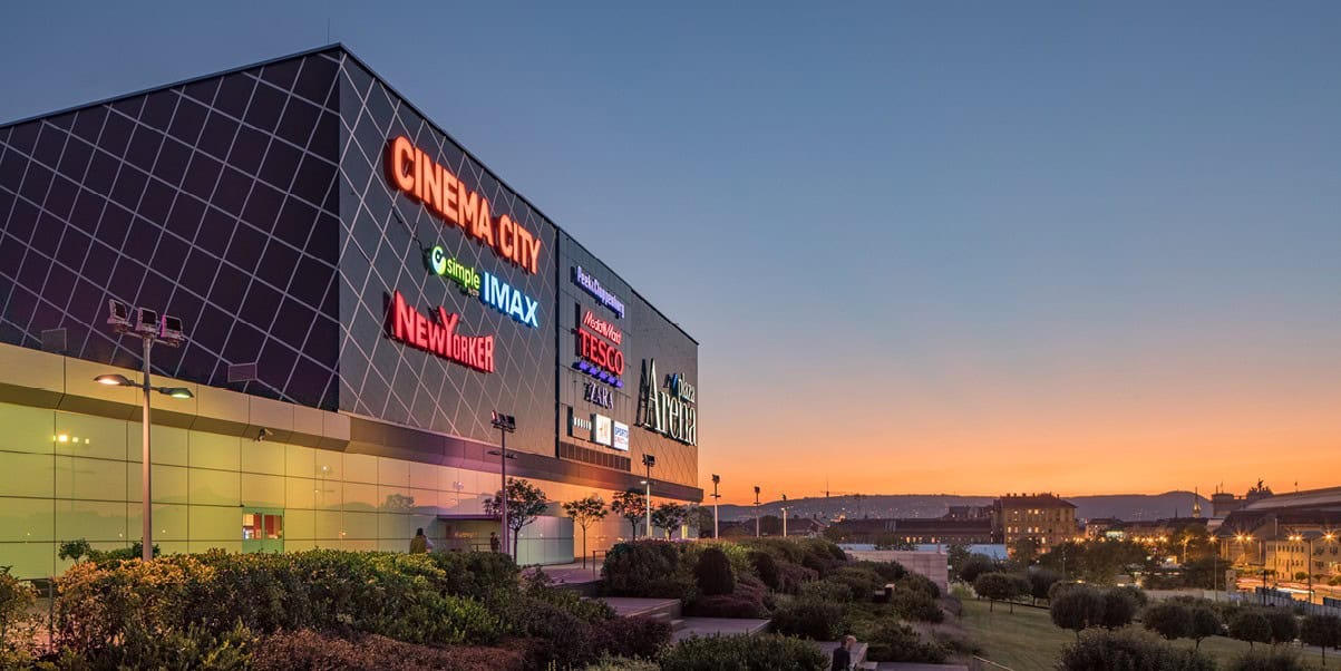 The modern exterior of Arena Mall in Budapest during sunset