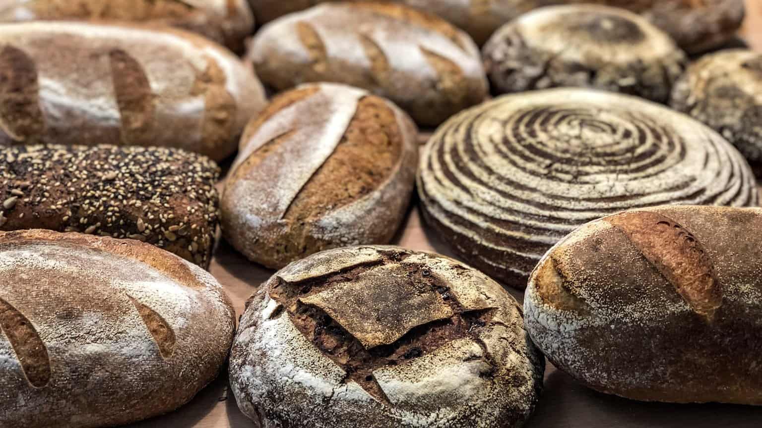 A variety of freshly baked artisanal sourdough bread loaves at a Budapest bakery
