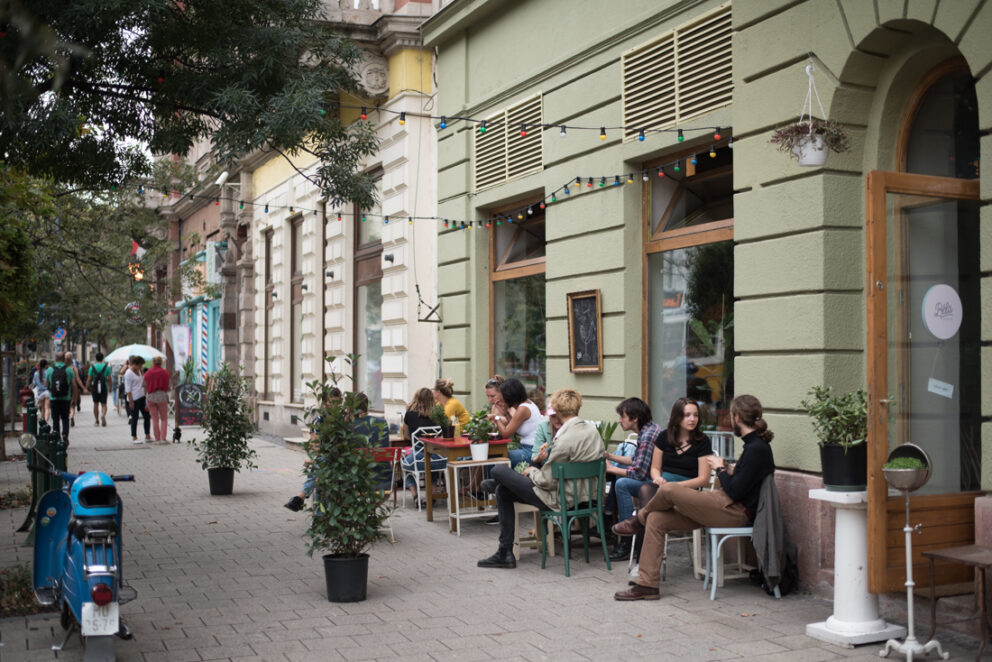 A cozy 'shabby chic' corner at Béla bar with green velvet armchairs