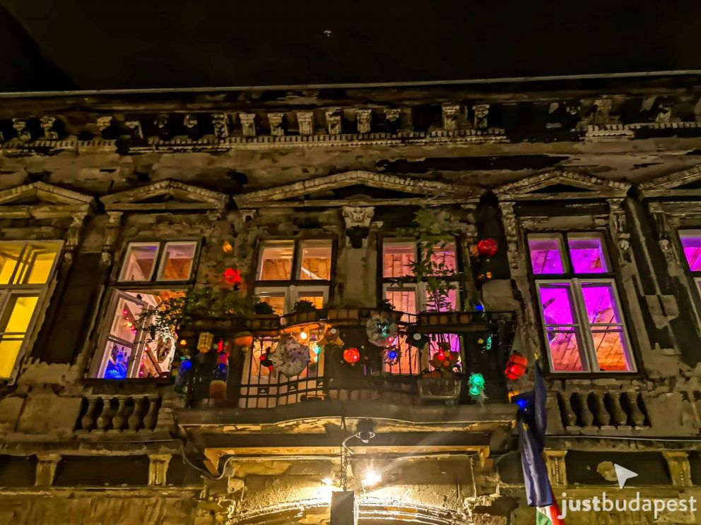 The façade of Szimpla Kert ruin pub in Budapest by night
