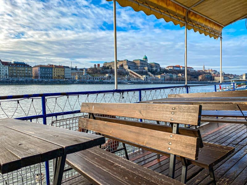The view of Buda Castle from the wooden deck of a BKK public riverboat