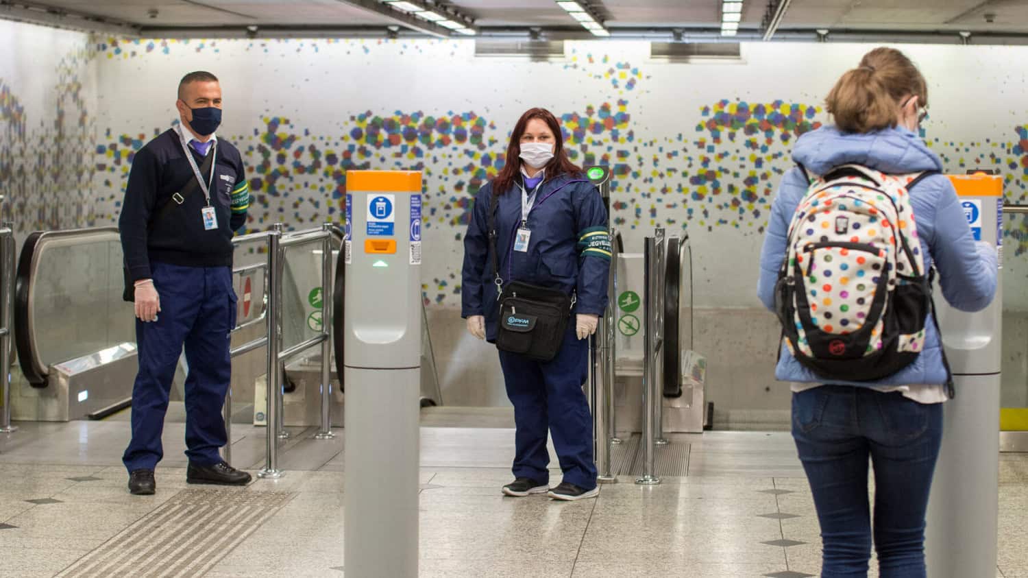 Ticket inspectors standing at the entrance of a Budapest metro station