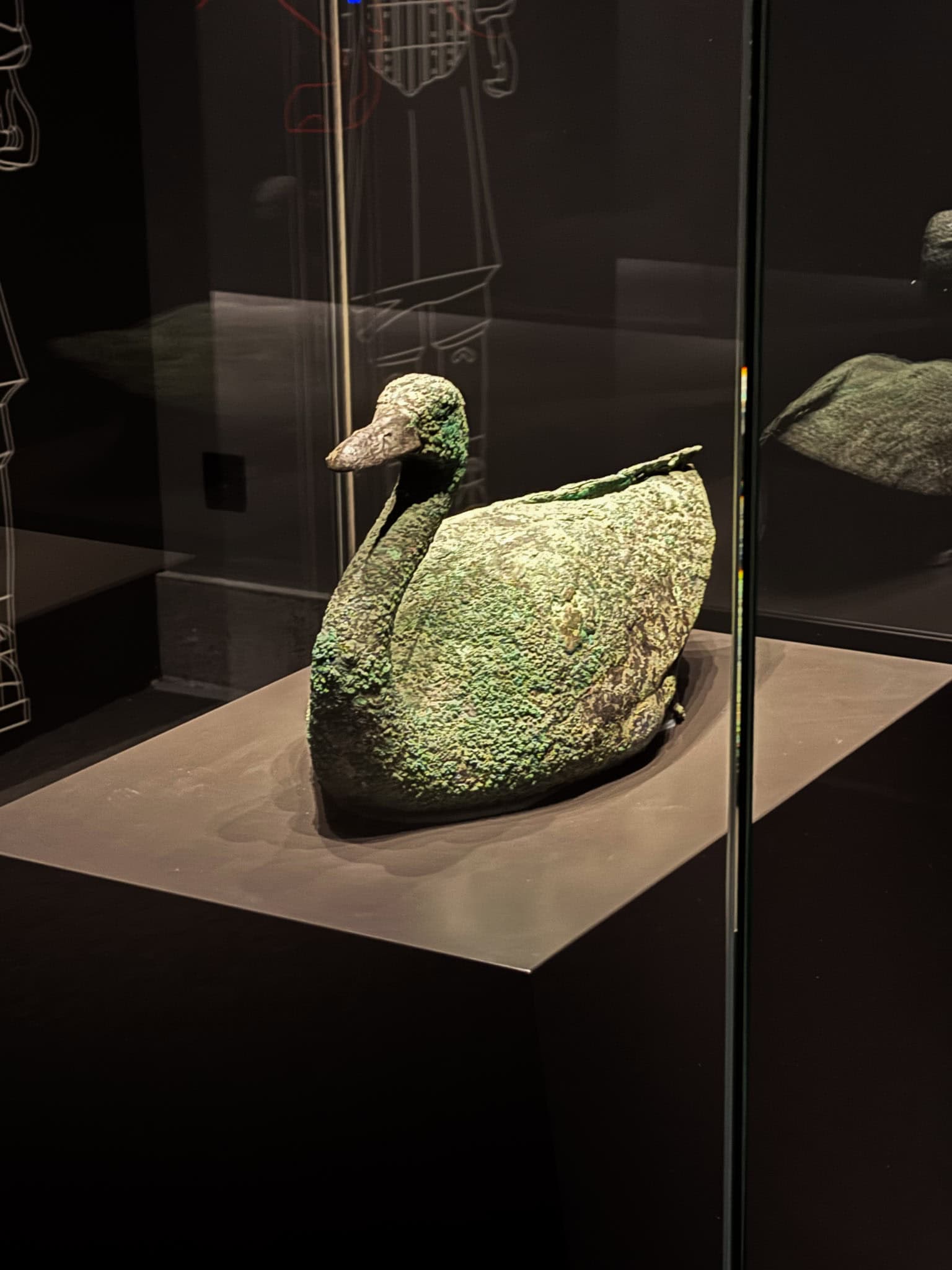 A realistic bronze sculpture of a waterbird