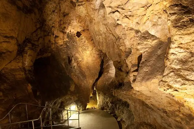 A dimly lit stone corridor inside the historic Buda Castle Labyrinth