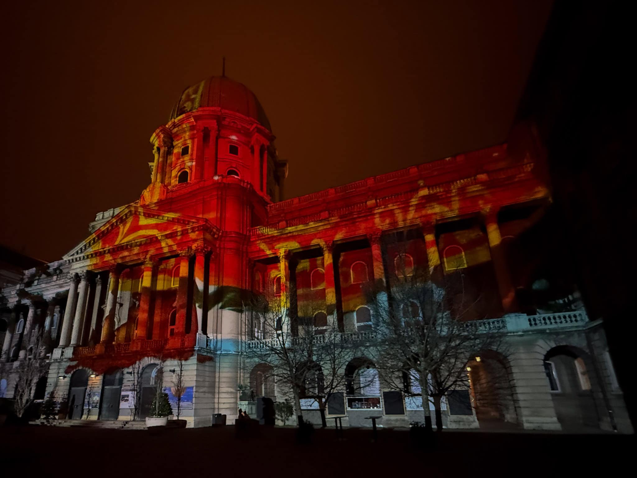 Red and gold Christmas light projection on Buda Castle