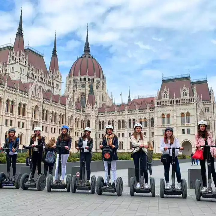 A Segway tour group posing in the courtyard of the Royal Palace