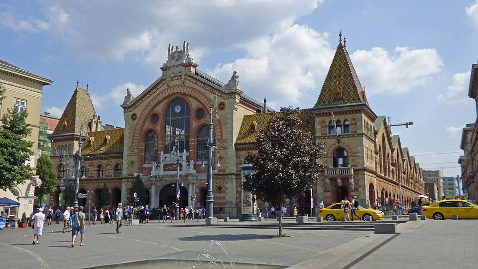 The main entrance and façade of the Central Market Hall in Budapest, with its iconic Zsolnay ceramic tiles