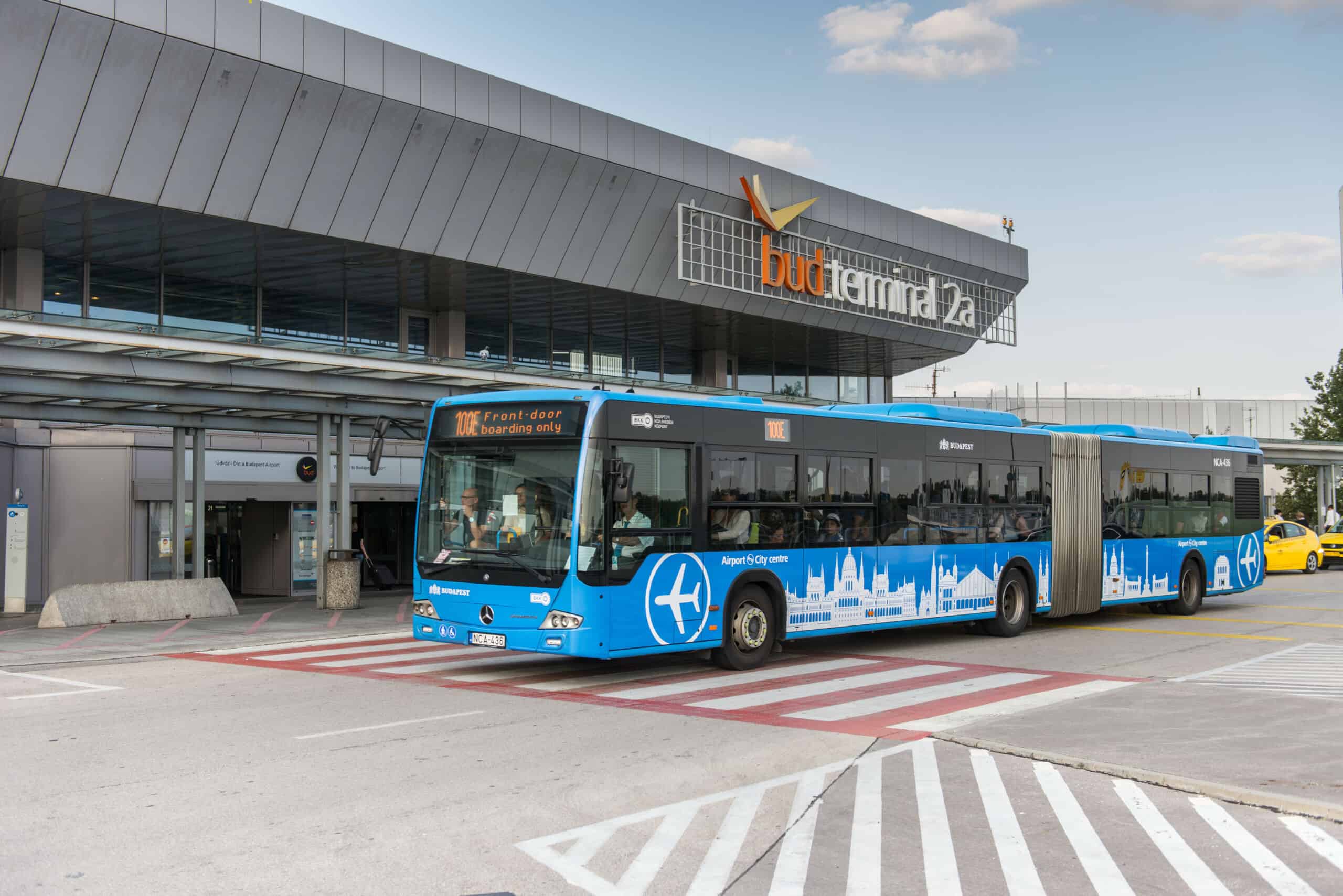 The blue 100E Airport Express bus waiting at the Terminal 2 bus station in Budapest