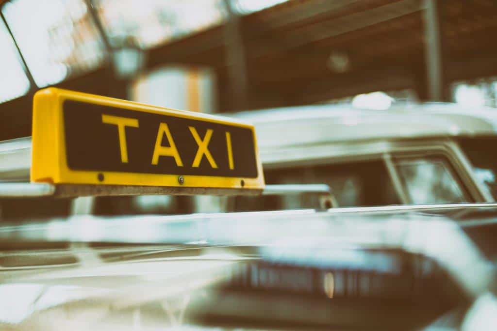 A row of yellow taxis waiting for passengers at the Budapest Airport Arrivals level