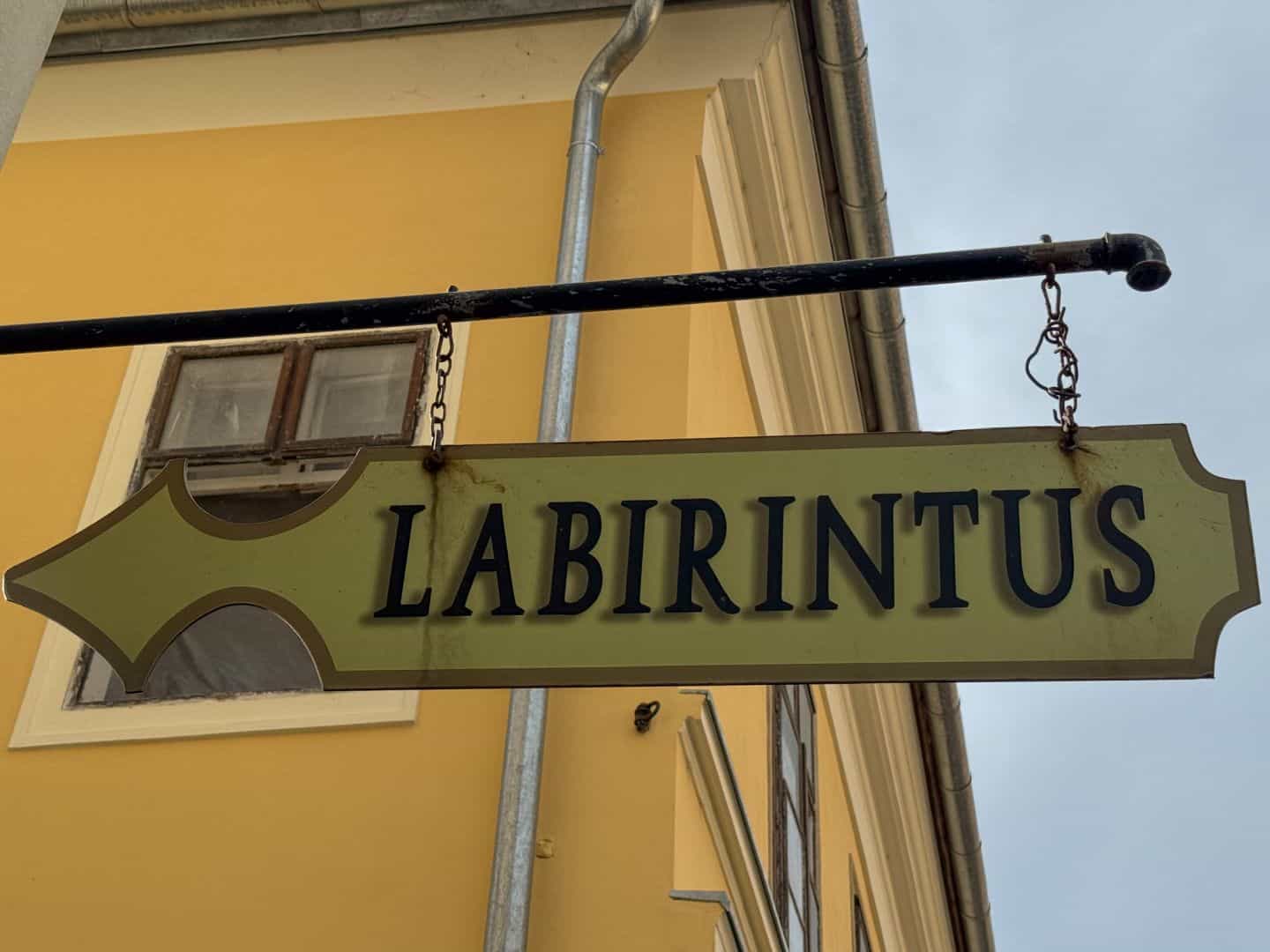 Atmospheric, warmly lit underground stone corridor in the Labyrinth of Buda Castle