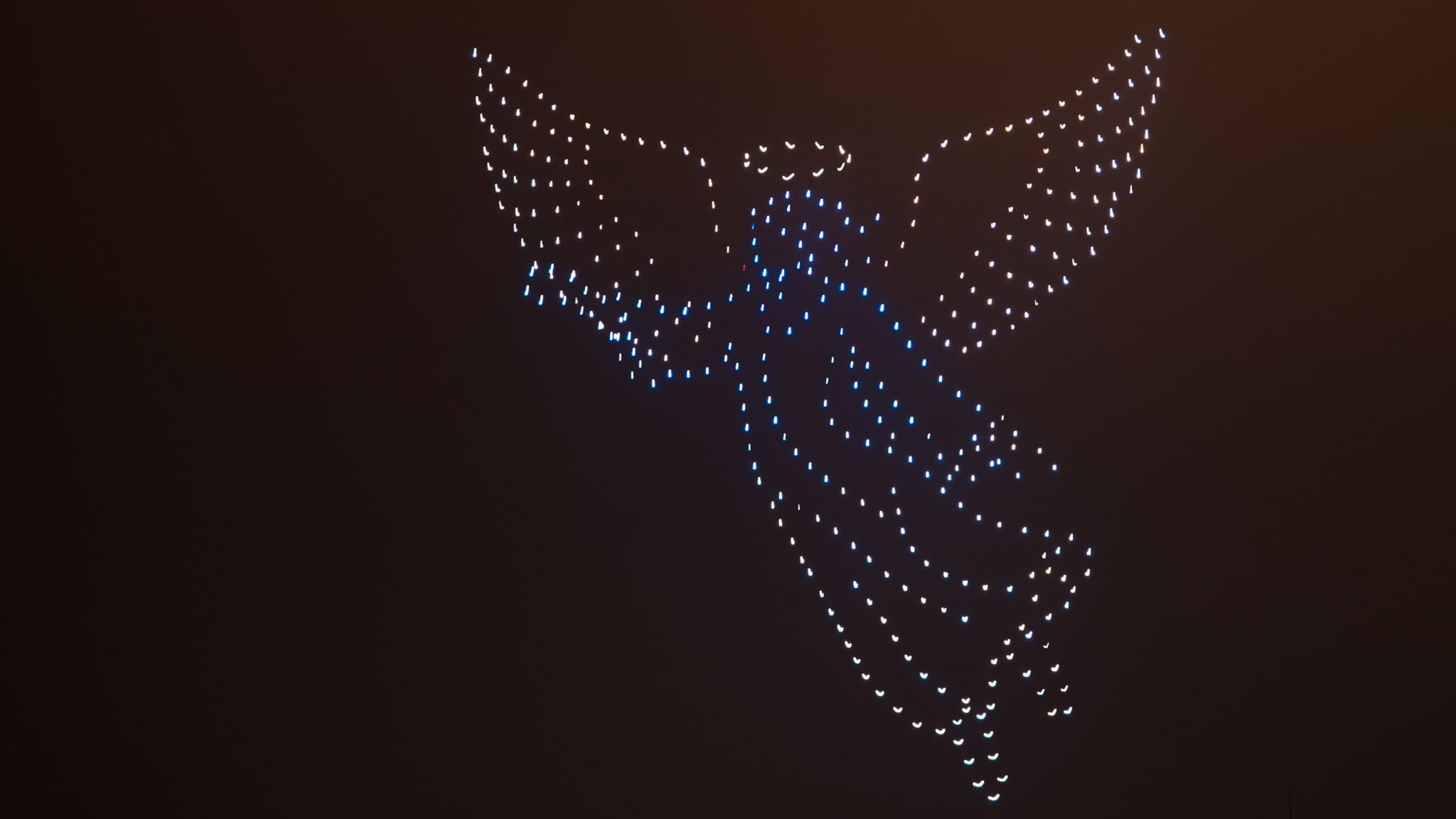 Drone light show forming an angel figure in the sky