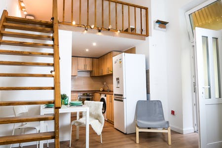 The spacious interior of a classical Budapest apartment with high ceilings and tall windows