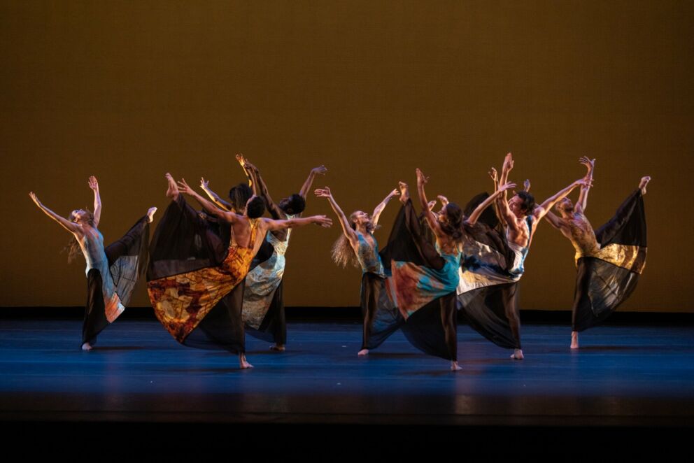 Dancers in bright costumes performing on stage at the Budapest Dance Festival