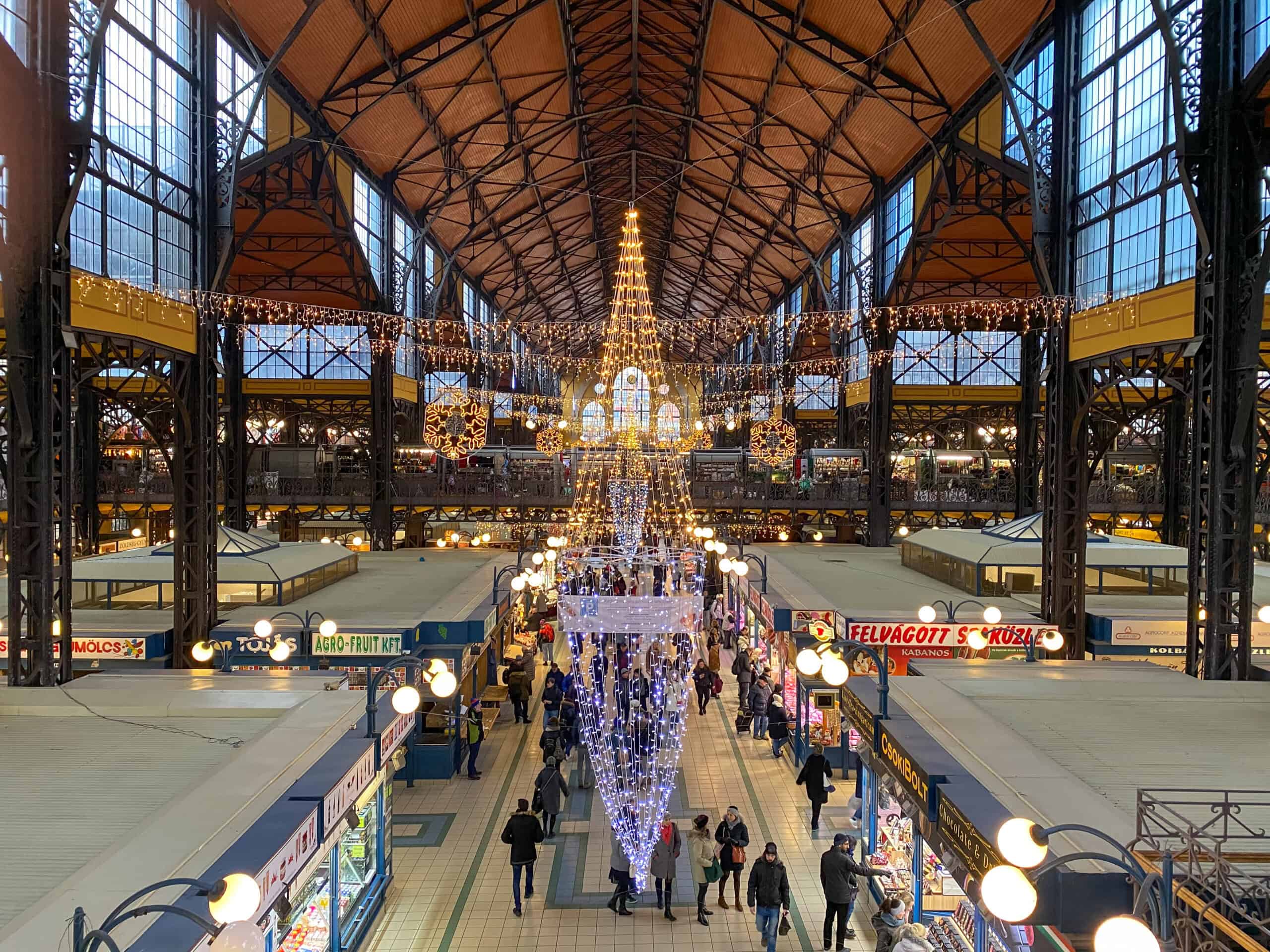 Inside the bustling Great Market Hall in Budapest during a rainy day