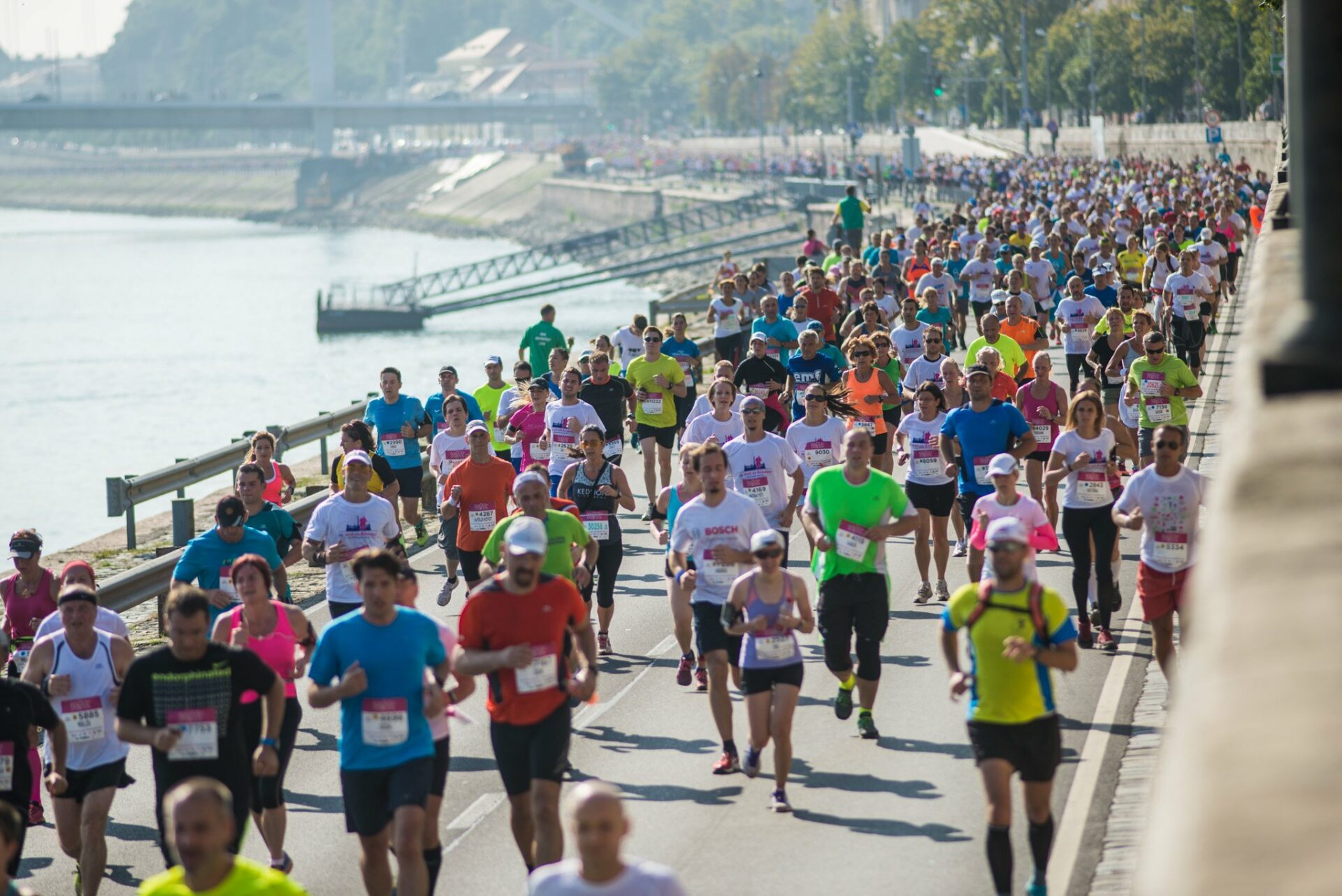 Thousands of runners participating in a marathon along the Danube riverbank in Budapest