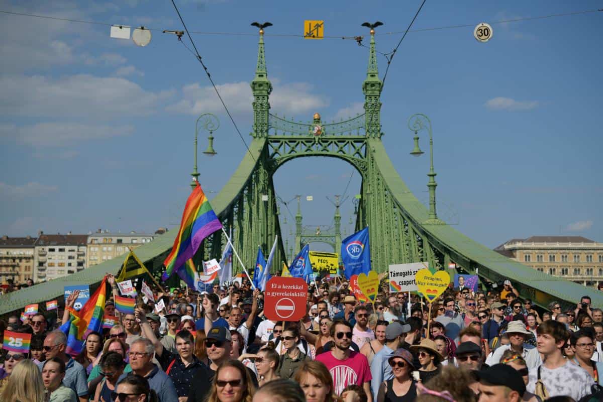 A massive crowd holding rainbow umbrellas during the Budapest Pride March