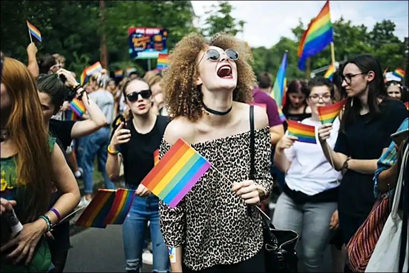 A joyful crowd waving rainbow flags at the Budapest Pride parade
