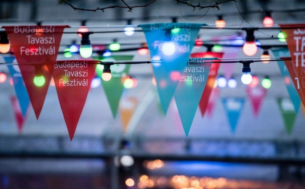 Contemporary dancers in vibrant red costumes performing at the Budapest Spring Festival