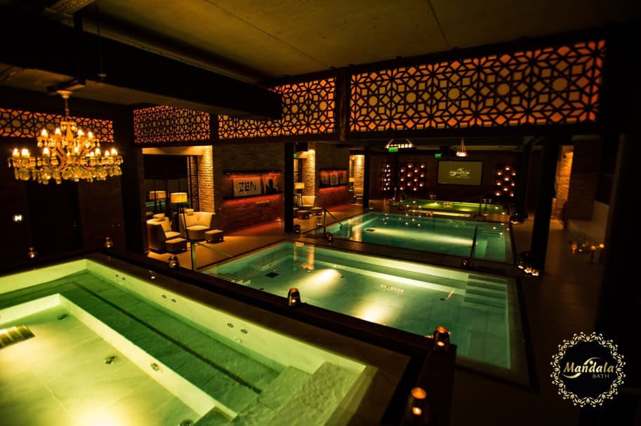 A professional therapist performing an authentic traditional Thai massage on a mat