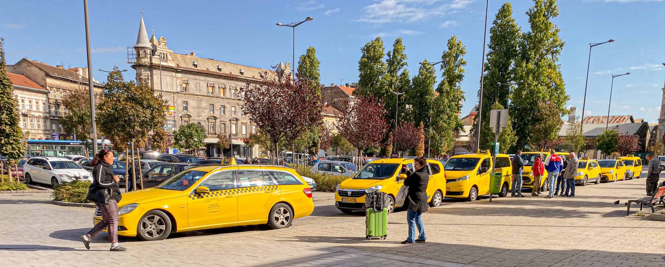 A licensed yellow taxi waiting near the Keleti station