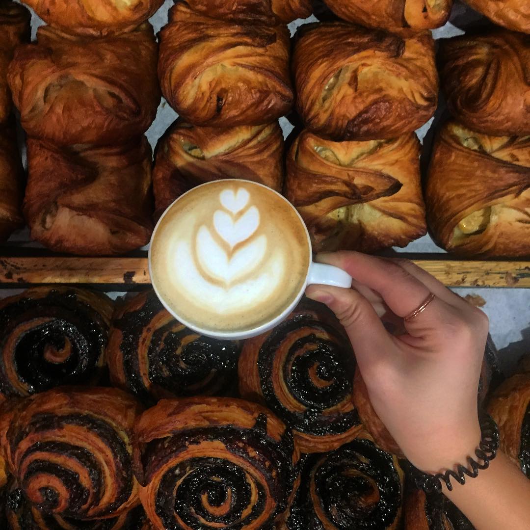 Artistic cappuccino and a fresh pastry at Butter Brothers bakery