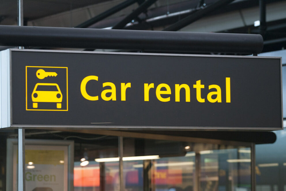 Several major car rental agency desks located in the airport arrivals hall