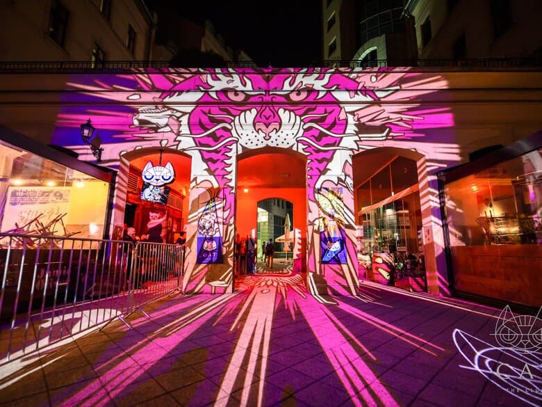 The entrance to CAT club in Budapest featuring a giant pink tiger projection