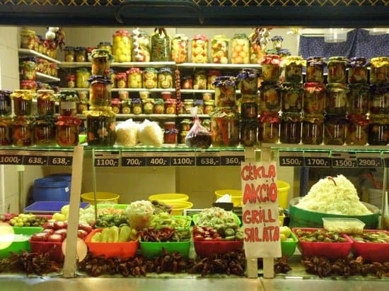 Large glass jars filled with intricately patterned pickled vegetables in the basement