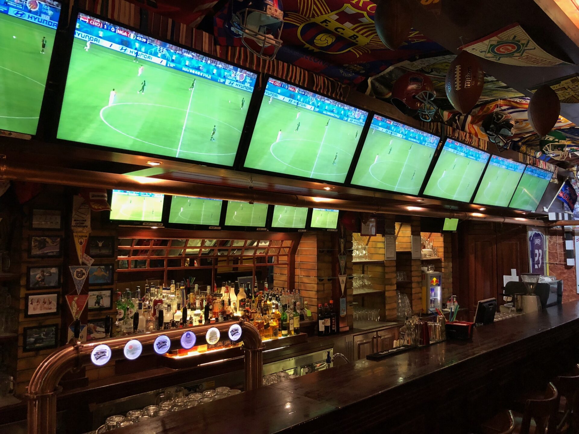 The screen-filled interior of Champs Sport Pub in downtown Budapest