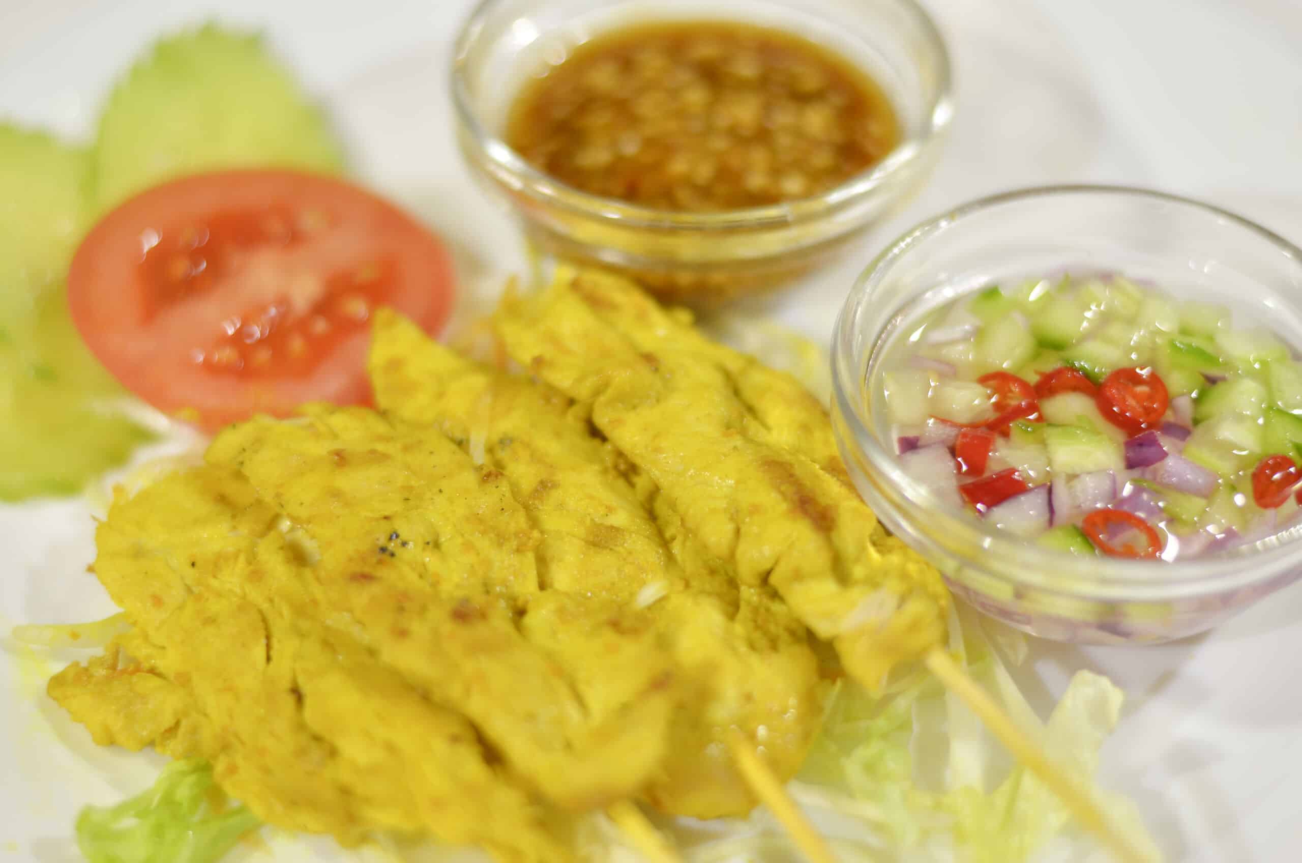 Grilled chicken satay skewers with peanut sauce and cucumber relish