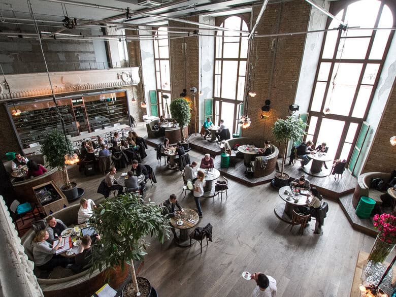 Stirring bright red paprika powder into sautéed onions in a cooking pan