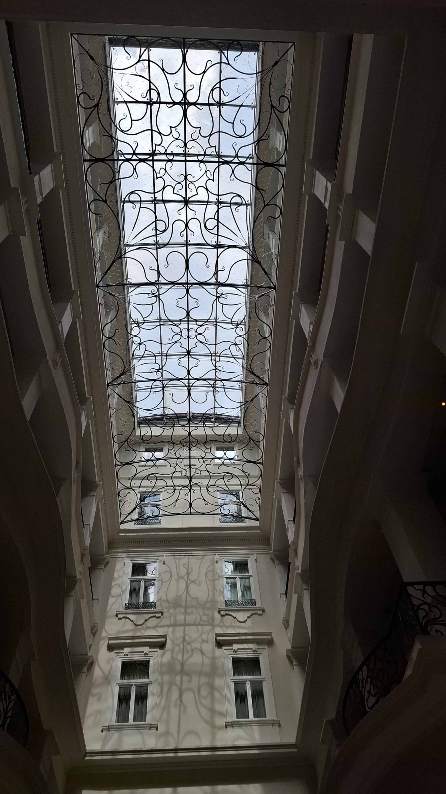 The elegant historic café inside the Corinthia Hotel featuring classic seating and a grand piano