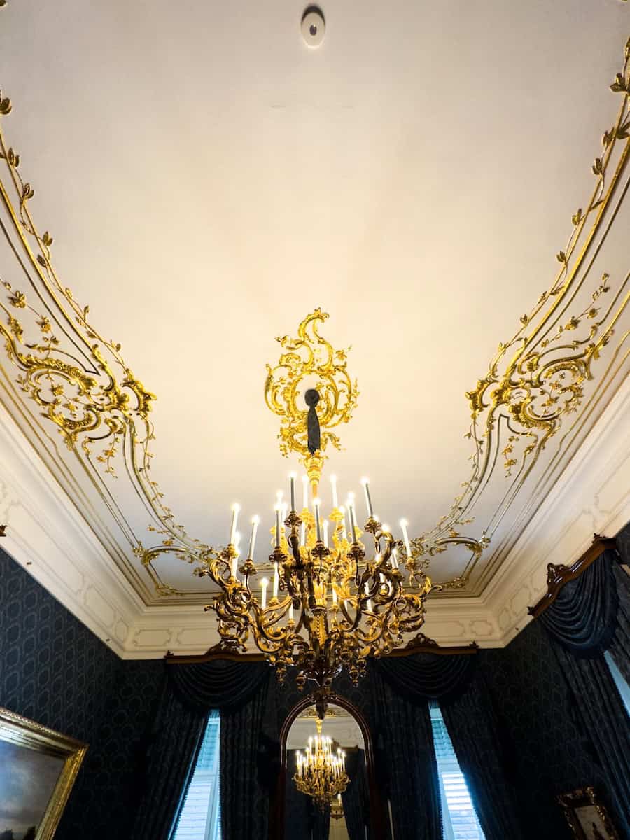 The massive crystal chandelier hanging in the Blue Salon