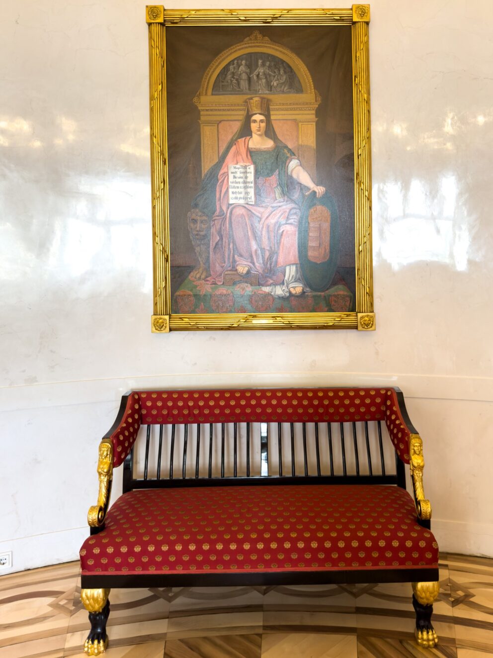 A curved antique sofa fitted into the wall of the Round Salon