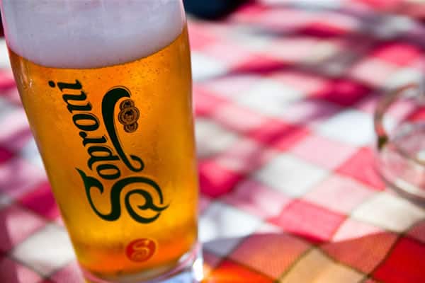 A glass of rich, dark 'barna sör' beer with a thick tan head