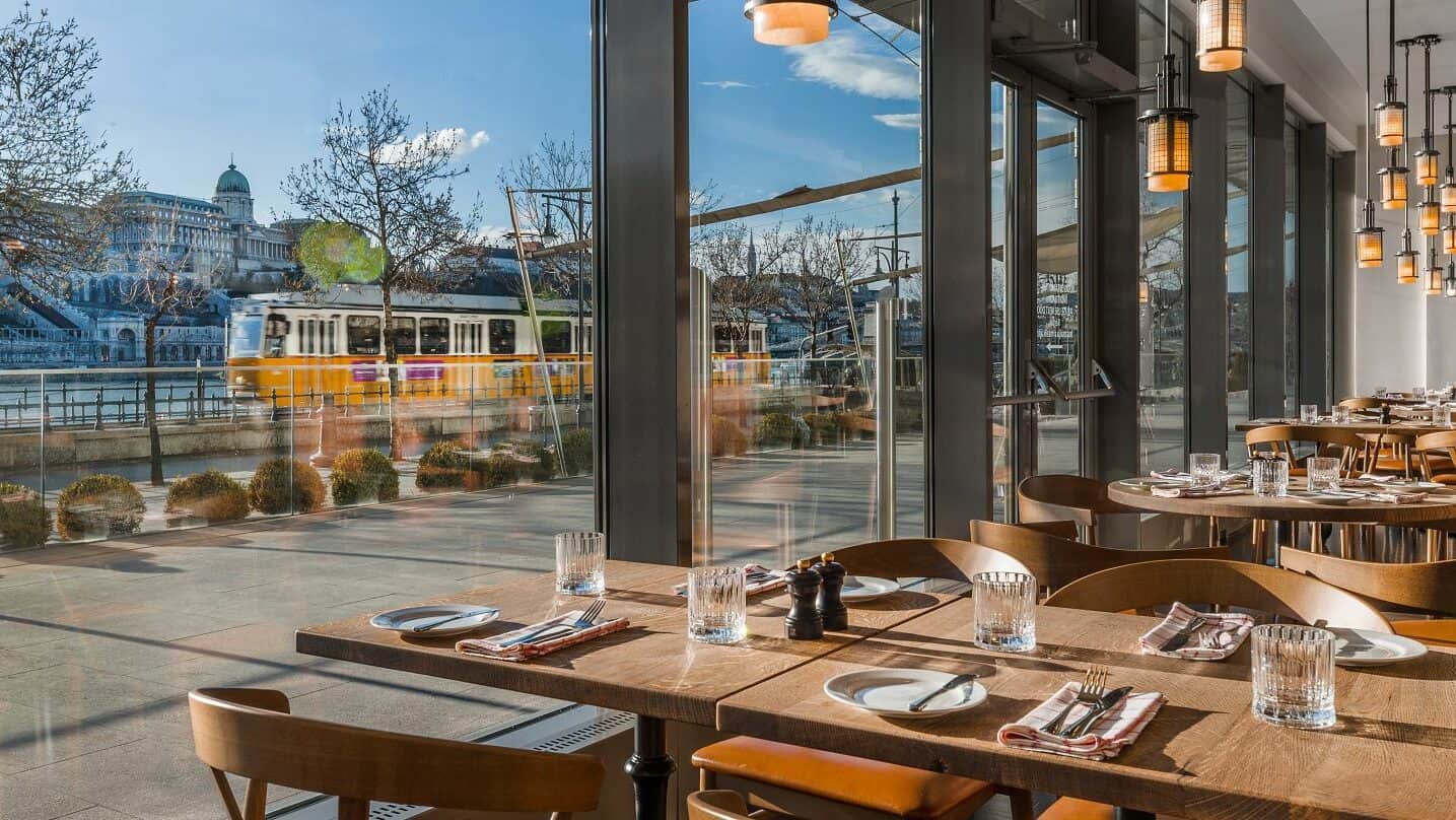 The stunning view of the Danube and a passing tram from DNB Restaurant
