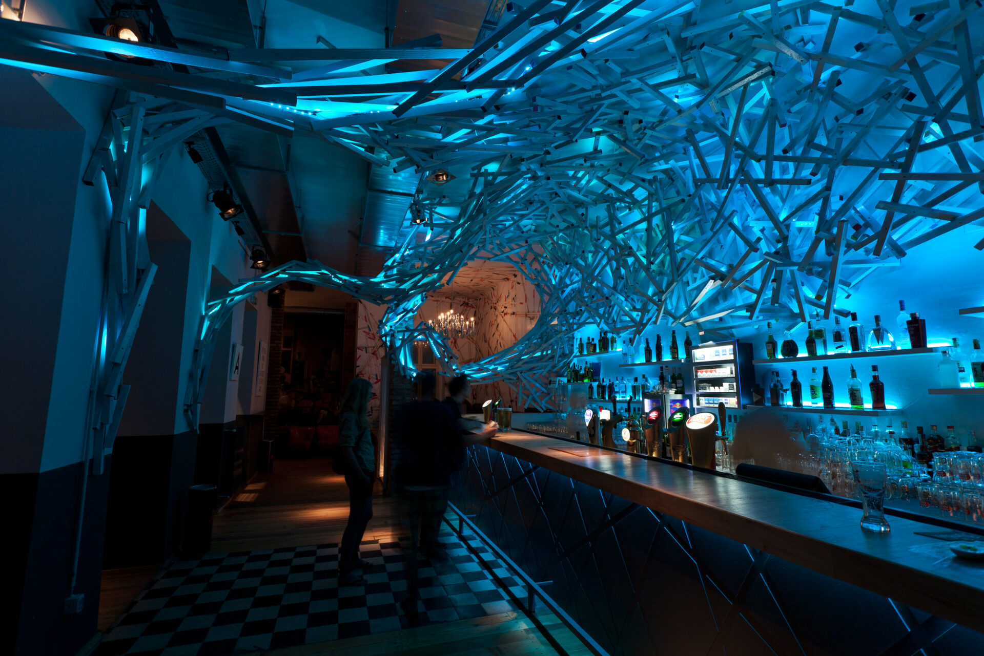 A crowded, energetic dance floor illuminated by strobe lights at Doboz nightclub